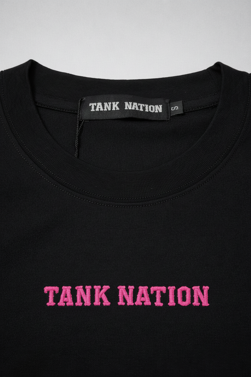 Black shirt with 'TANK NATION' text in pink and a visible brand tag on a WHITE background